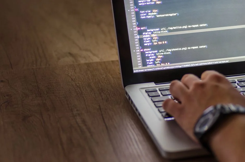 A contemporary workspace showcasing a laptop, tablet, and smartphones, ideal for tech and freelance use.